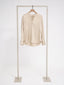 Silk blouse, signature cut.